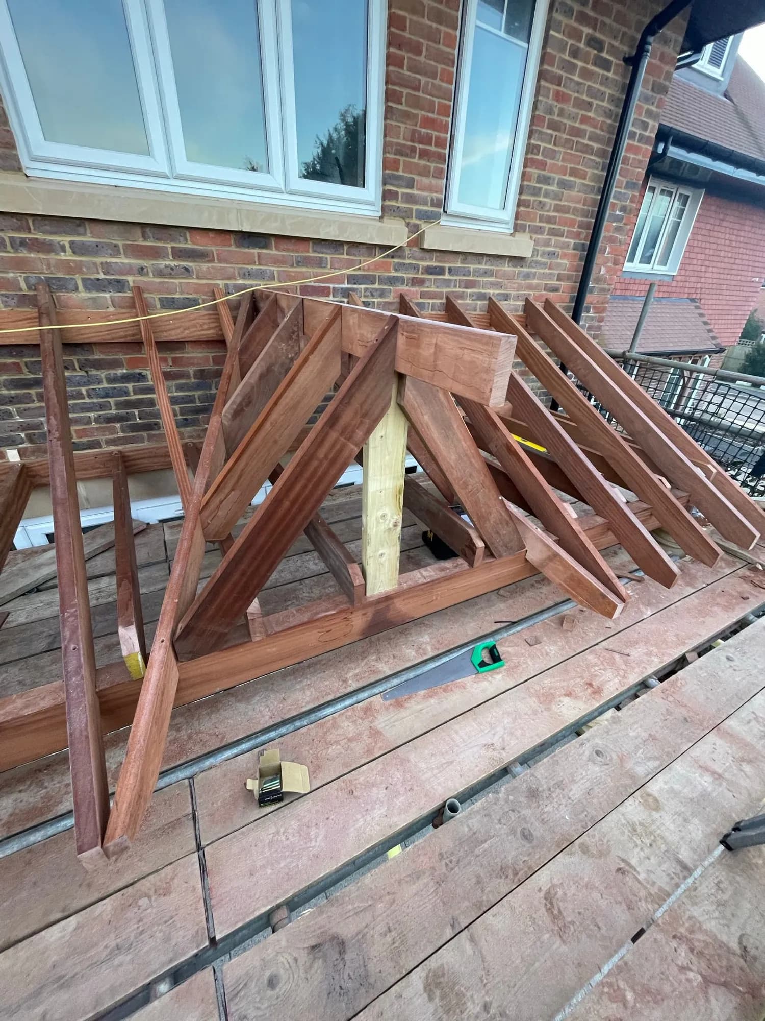 A hand-cut and pitched hardwood roof structure Capstone assembled on site