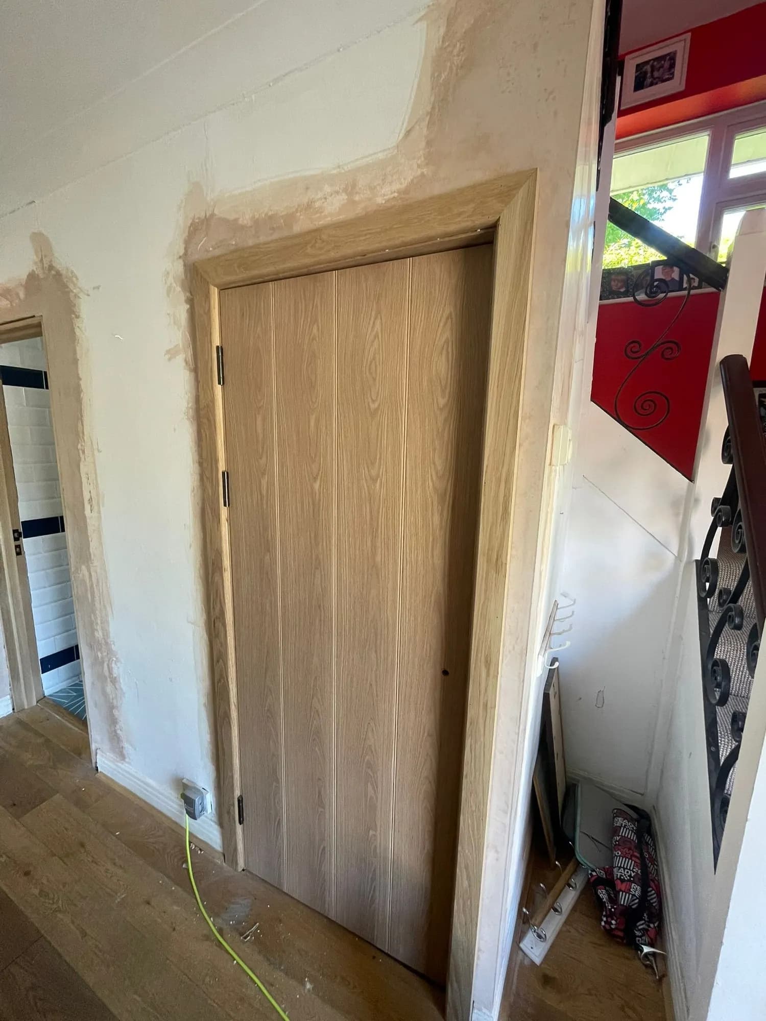 Bespoke hardwood front door with a dark painted finish and a slim glazed panel