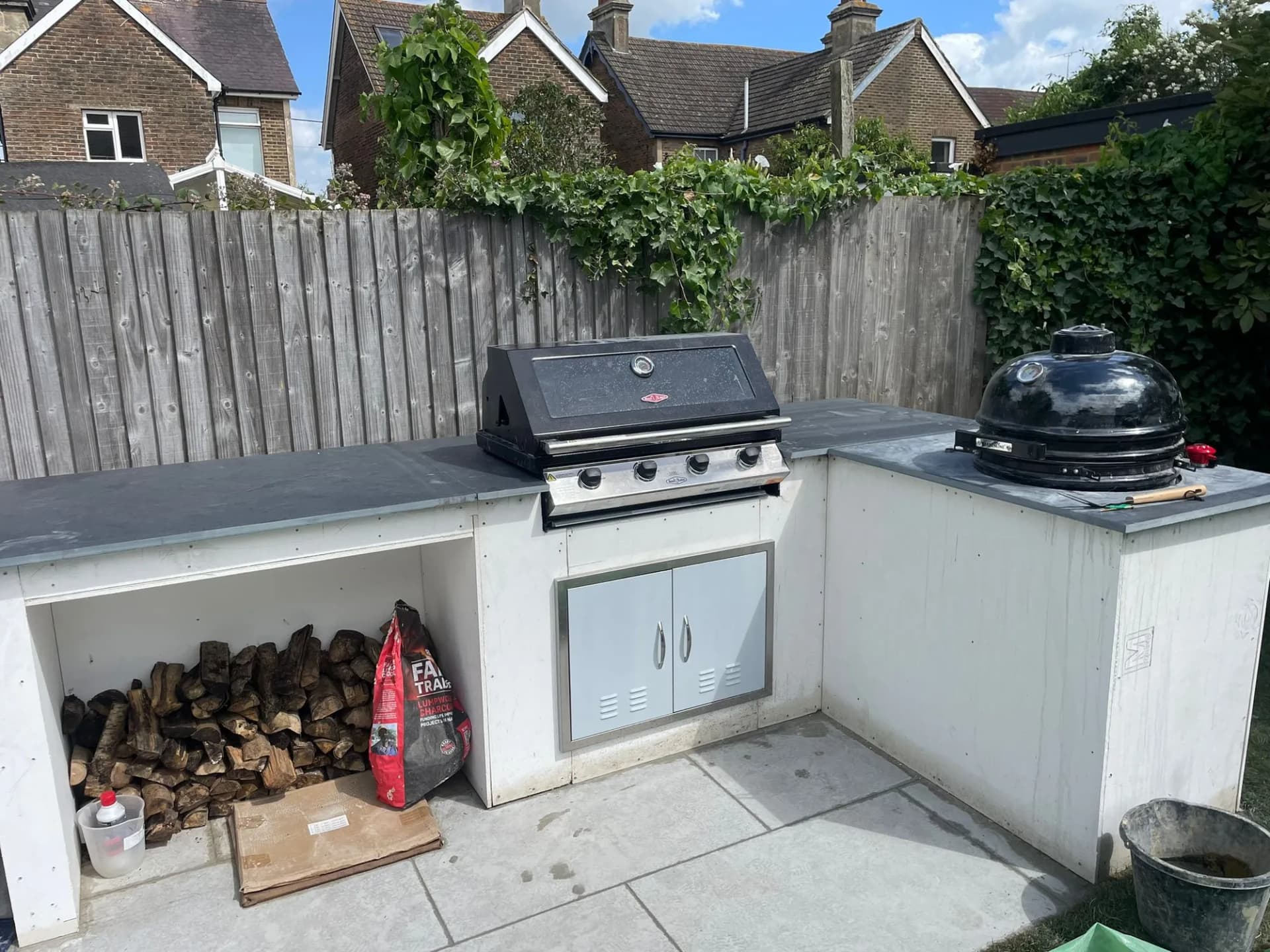An outdoor kitchen with built-in grill and zinc worktops built by Capstone