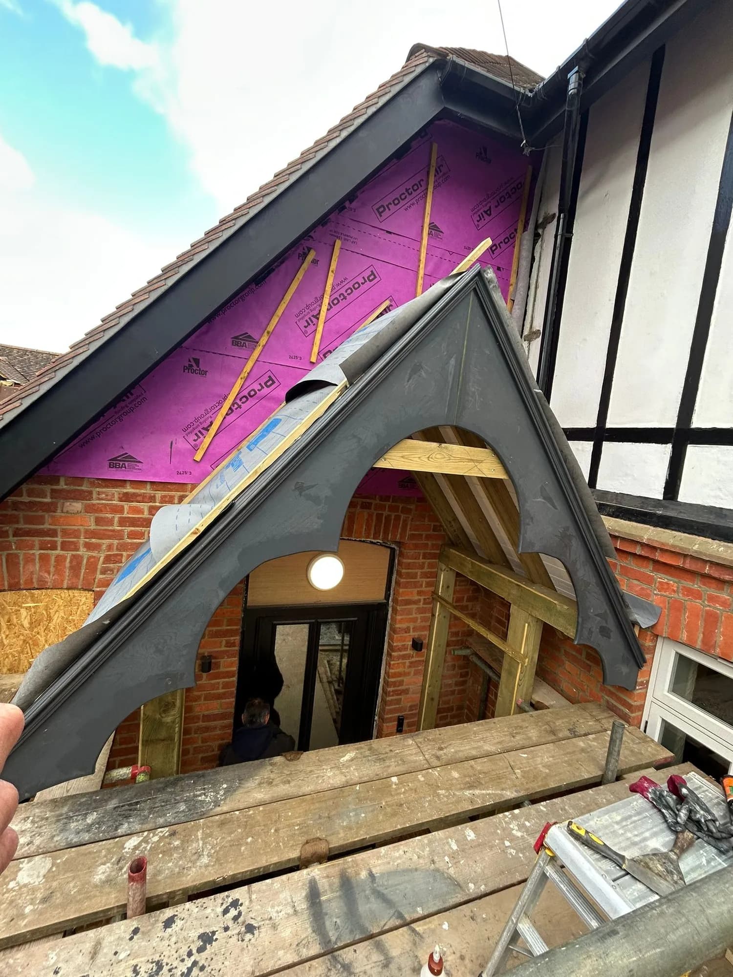 A cut-and-pitch porch with custom shaped fascia detailing by Capstone